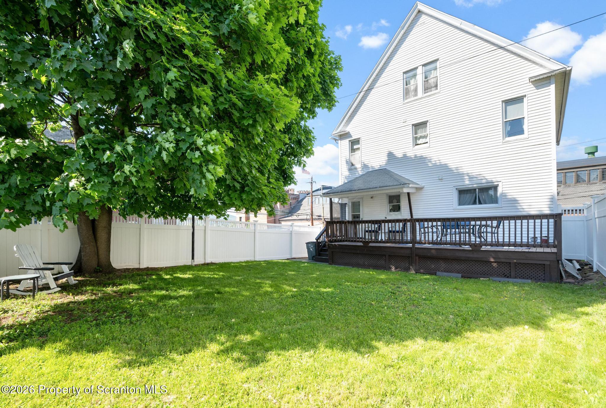 616 Myrtle Street Scranton, PA 18510 - Photo 64 of 65 a view of a house with a yard and a large tree