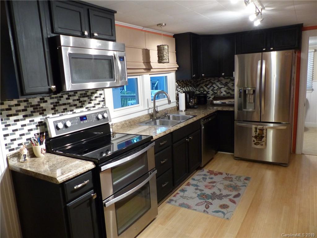 475 Brooks Lake Road Rutherfordton, NC 28139 - Photo 11 of 28 a kitchen with granite countertop a sink stove and refrigerator