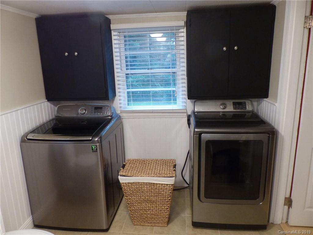 475 Brooks Lake Road Rutherfordton, NC 28139 - Photo 15 of 28 a kitchen with granite countertop white cabinets and black appliances