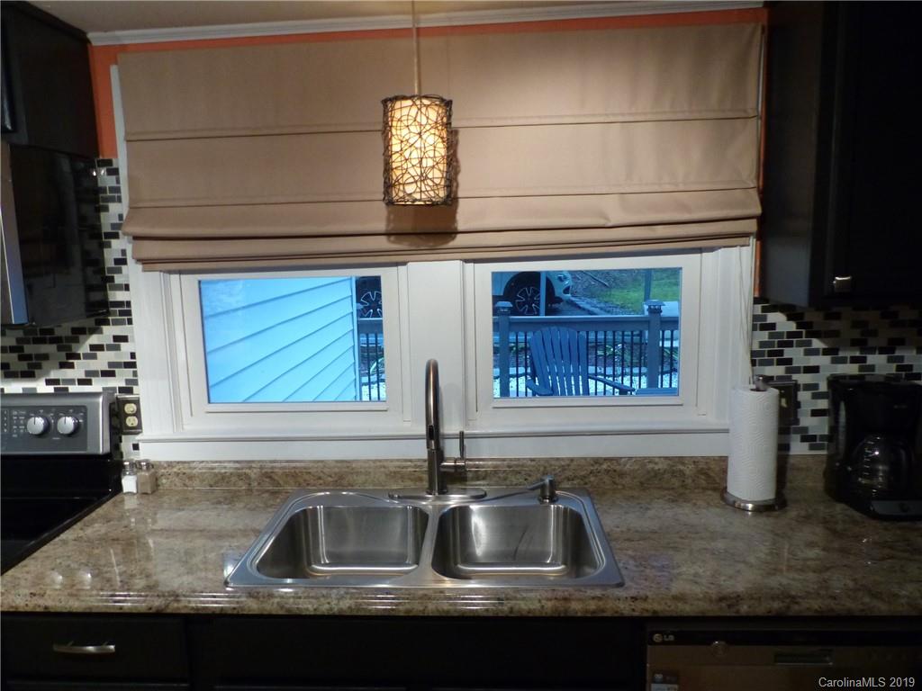475 Brooks Lake Road Rutherfordton, NC 28139 - Photo 16 of 28 a kitchen with granite countertop a sink and a stove