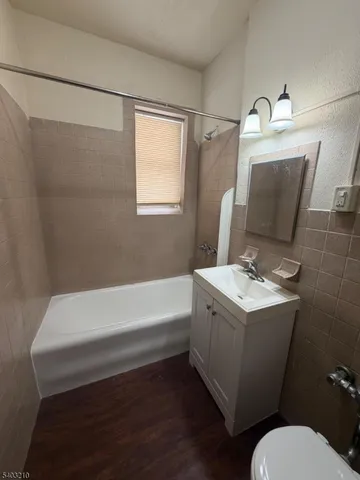 a bathroom with a sink a toilet and bathtub