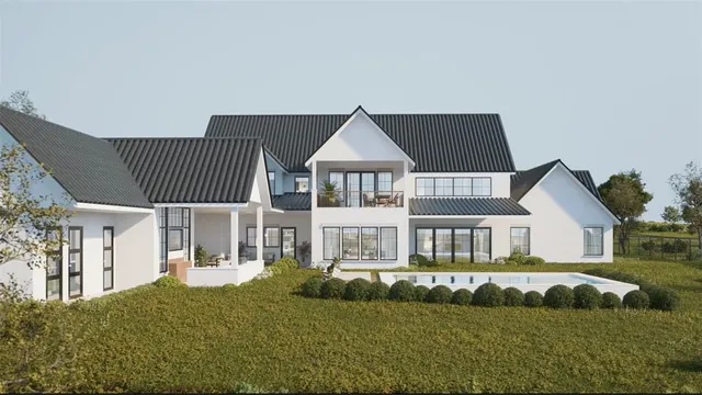 a view of a house with backyard and sitting area