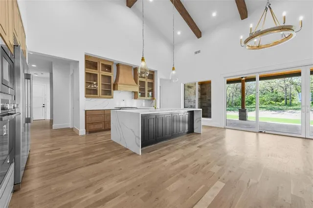 a living room with lots of furniture and a large window