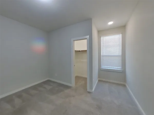 an empty room with closet area