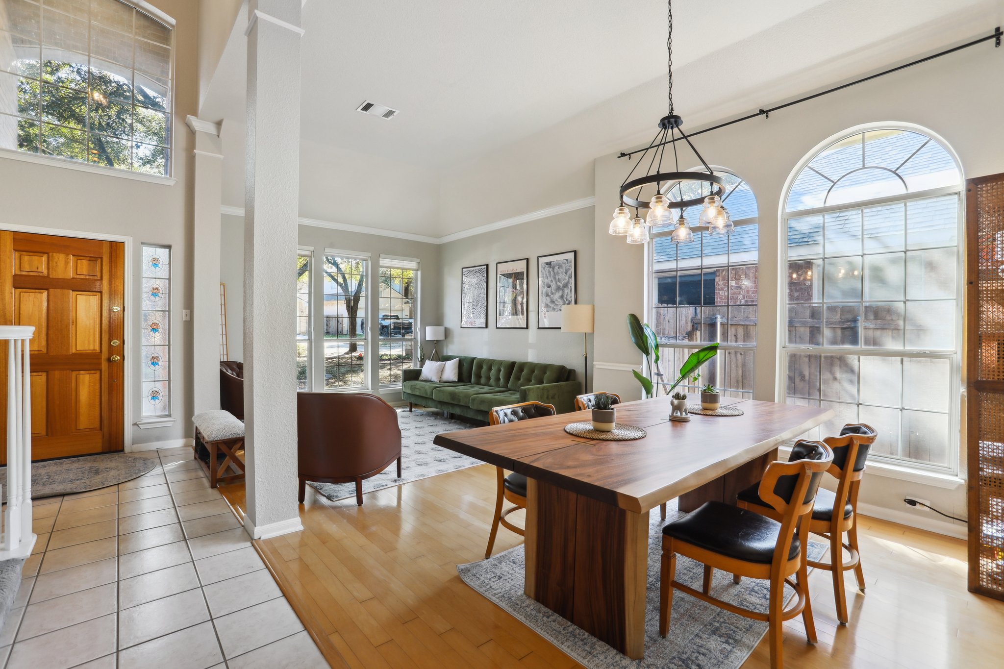 13541 Anarosa Loop Austin, TX 78727 - Photo 4 of 27 Open-concept living and dining areas featuring high ceilings and abundant natural light