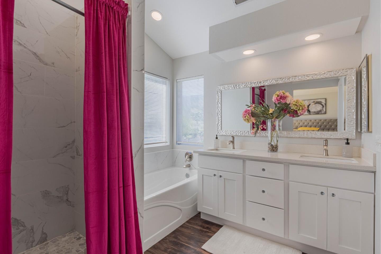 25215 Azalea Court Salinas, CA 93908 - Photo 32 of 48 a spacious bathroom with a double vanity sink a large mirror and a bathtub