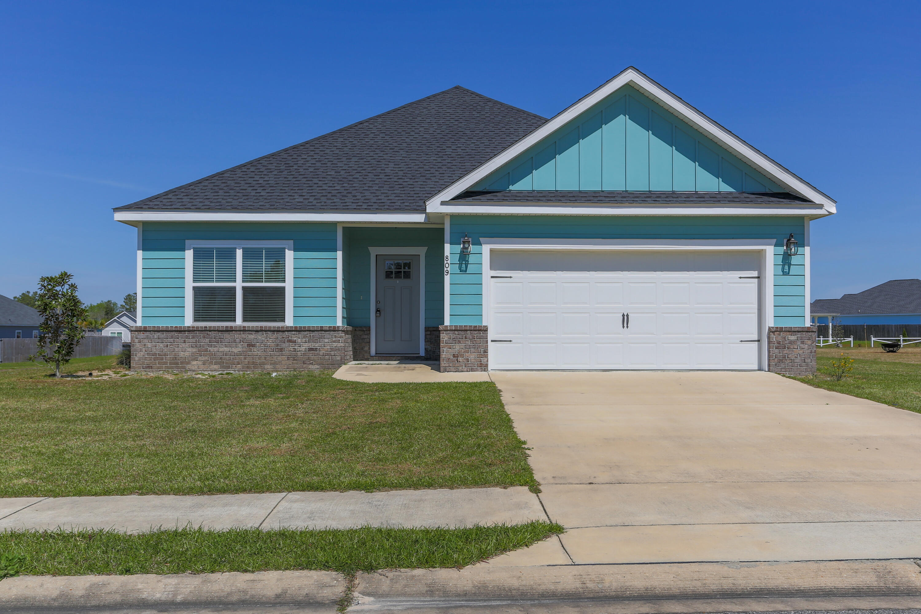 a front view of a house with a yard and garage