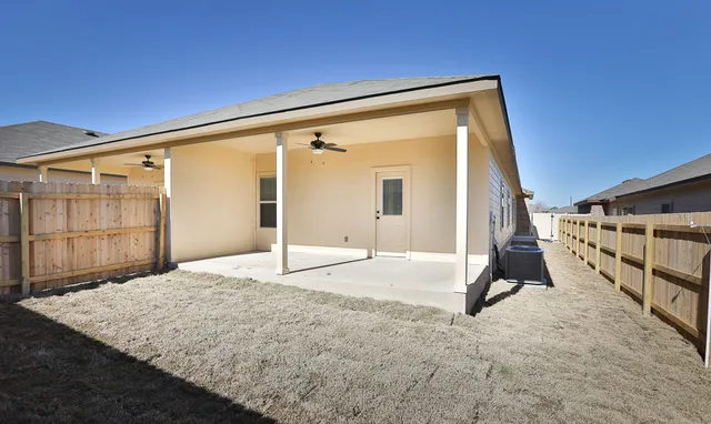 a view of a back yard with car parked