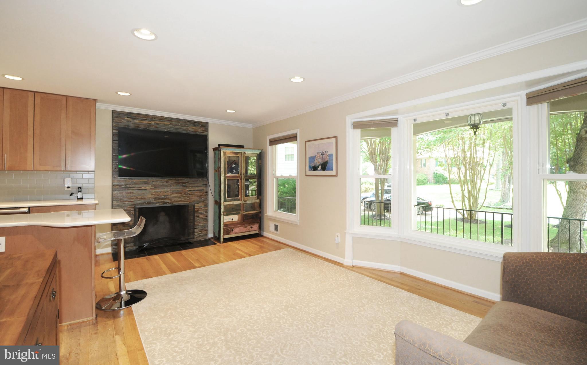 7821 Elba Road Alexandria, VA 22306 - Photo 18 of 54 STONE TILE SURROUNDS THE BREAKFAST AREA FIREPLACE