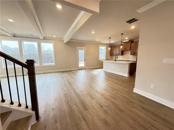 a view of livingroom with chandelier and wooden floor