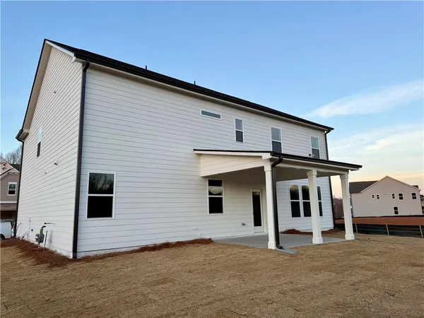 a view of a big room with wooden floor and windows