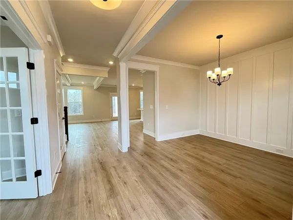 a large kitchen with kitchen island a stove a sink a refrigerator and wooden floor