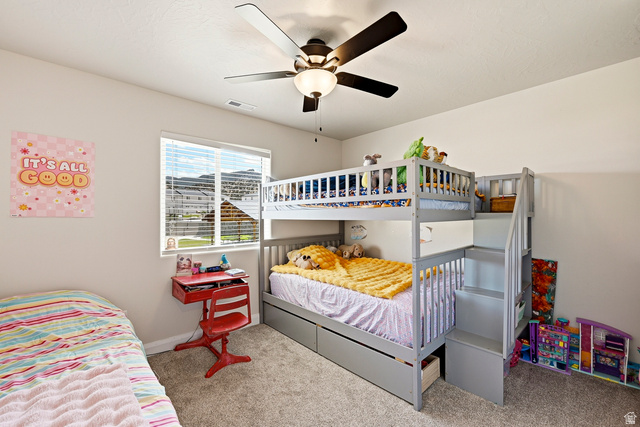 668 East Fiddlers Canyon Road, Unit 6 Cedar City, UT 84721 - Photo 22 of 36 Bedroom featuring neutral wall colors, carpet flooring, a window with blinds, and a ceiling fan with integrated lighting