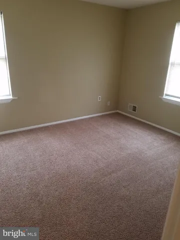 a view of an empty room and a window
