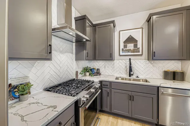 a kitchen with a sink stove and refrigerator