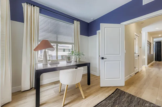 a dining room with wooden floor and a table
