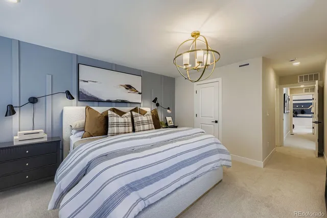 a bedroom with bed and wooden floor