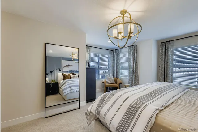 a bedroom with a bed and a chandelier