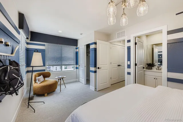 a bedroom with furniture and a flat screen tv