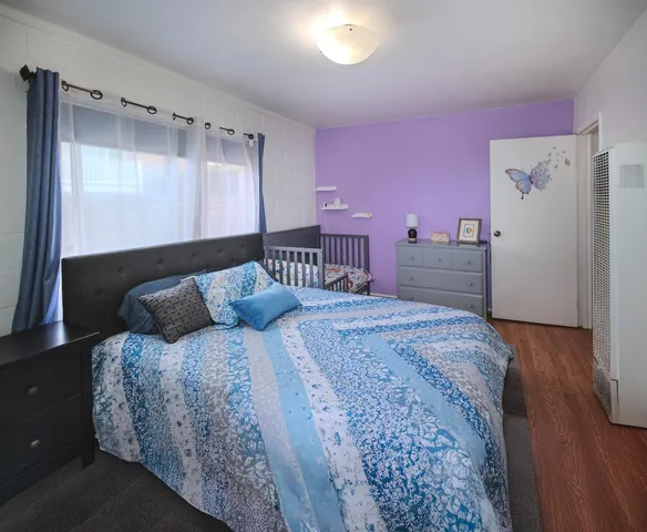 a bedroom with a bed and a dresser