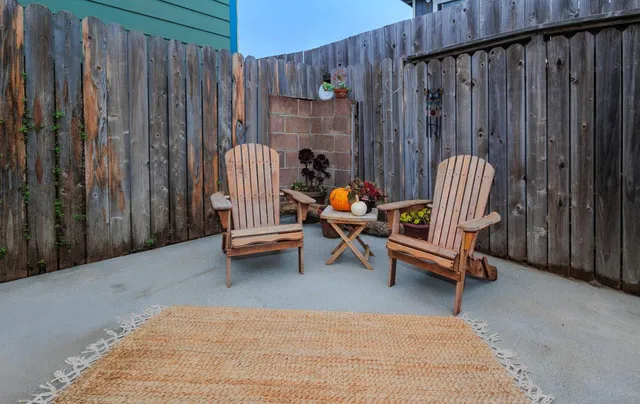 a backyard with swimming pool and wooden fence