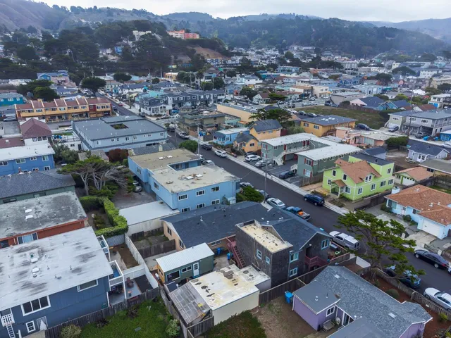 an aerial view of residential houses with outdoor space
