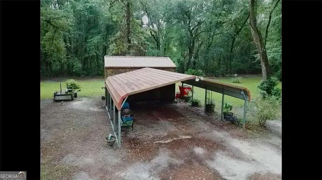 a backyard of a house with table and chairs