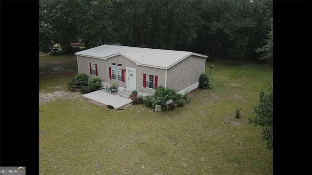 an aerial view of a house with pool table and chairs