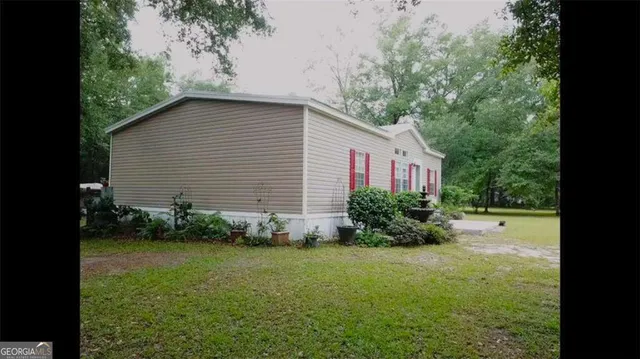 a living room with furniture and a dining table with wooden floor