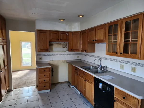 a kitchen with stainless steel appliances a sink stove and cabinets