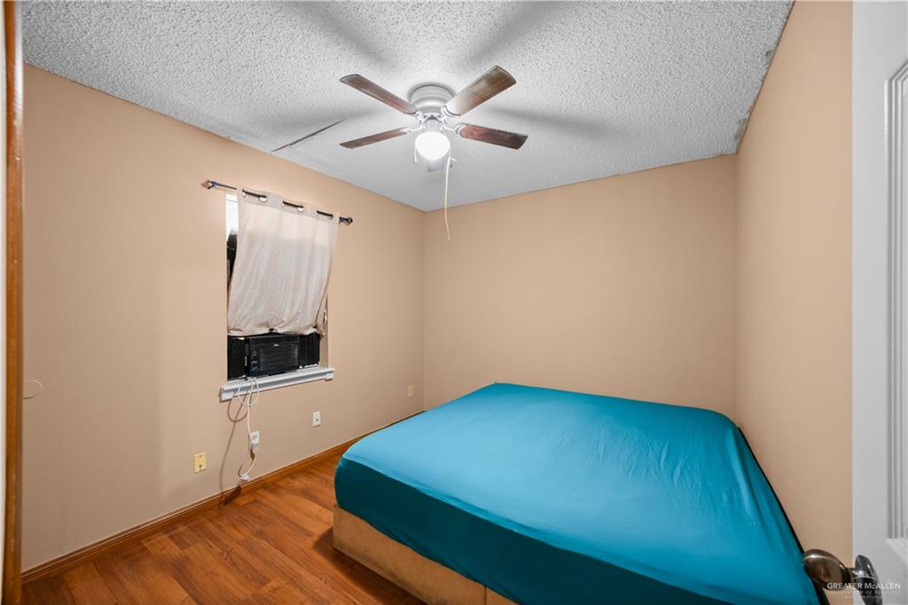 912 Rankin Street Mission, TX 78572 - Photo 11 of 17 wooden floor in an empty room with a window