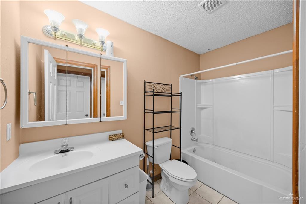 912 Rankin Street Mission, TX 78572 - Photo 12 of 17 a bathroom with a sink toilet and shower