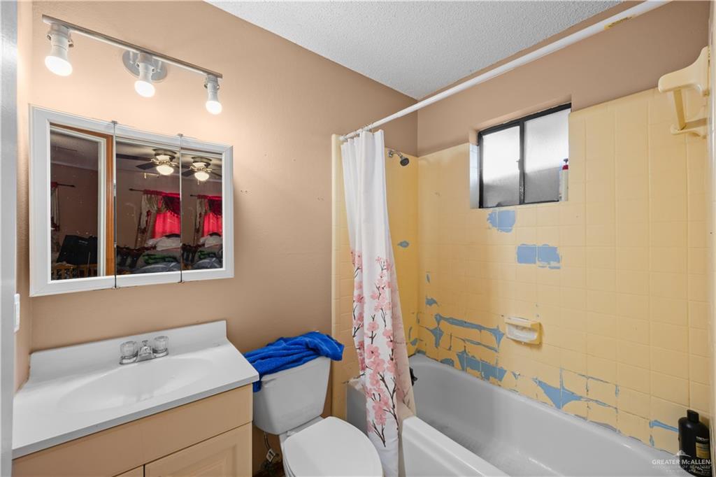 912 Rankin Street Mission, TX 78572 - Photo 13 of 17 a bathroom with a sink and a mirror
