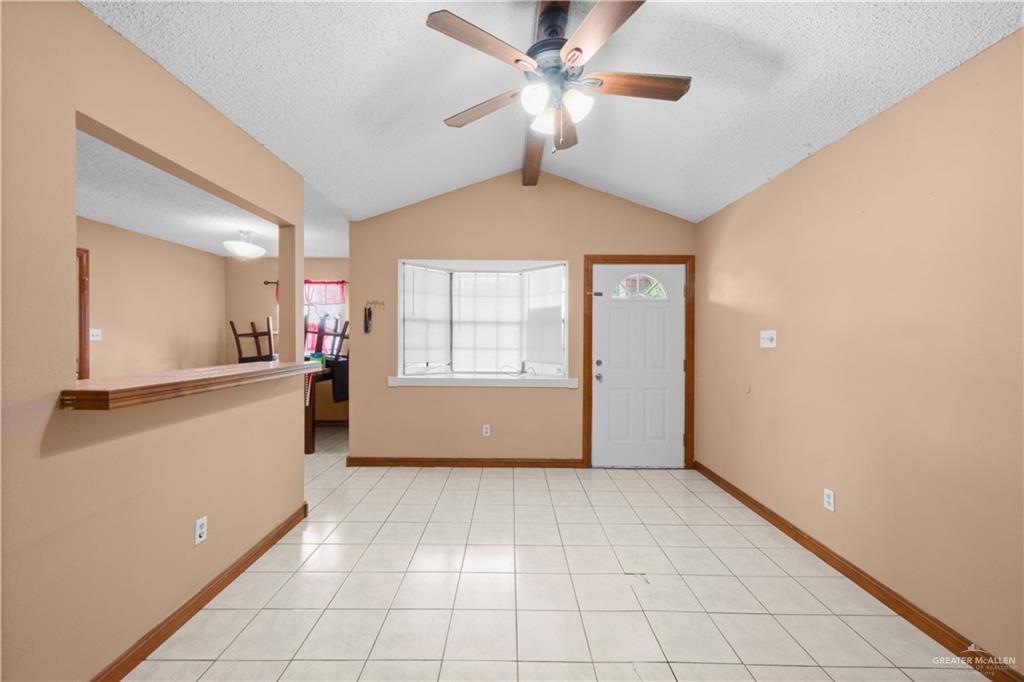 912 Rankin Street Mission, TX 78572 - Photo 3 of 17 a view of a livingroom with a chandelier fan and windows