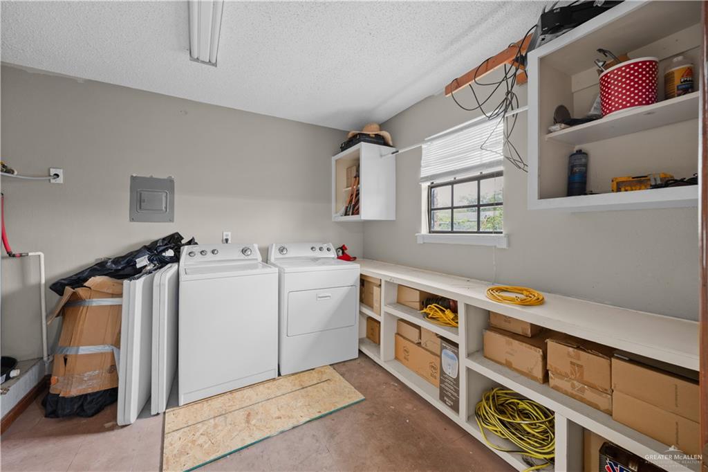 912 Rankin Street Mission, TX 78572 - Photo 8 of 17 a utility room with cabinets dryer and washer