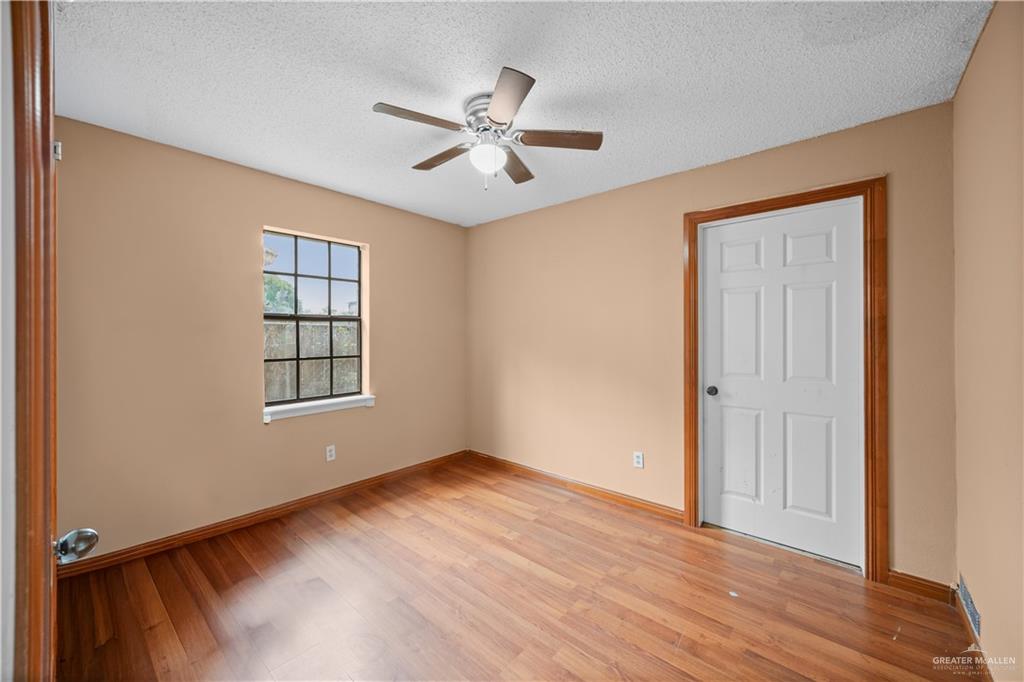 912 Rankin Street Mission, TX 78572 - Photo 9 of 17 a view of an empty room with wooden floor and a window