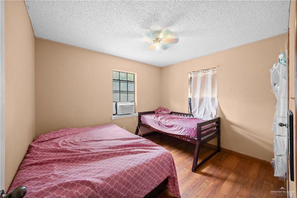 912 Rankin Street Mission, TX 78572 - Photo 10 of 17 a bedroom with two beds and a chandelier