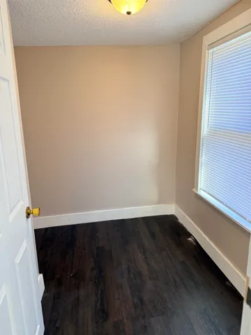 a picture of a bench in front of a white house