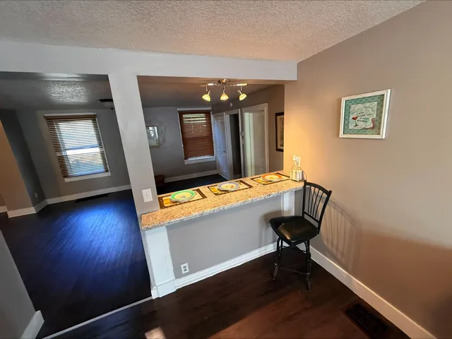 a view of a room with wooden floor and windows