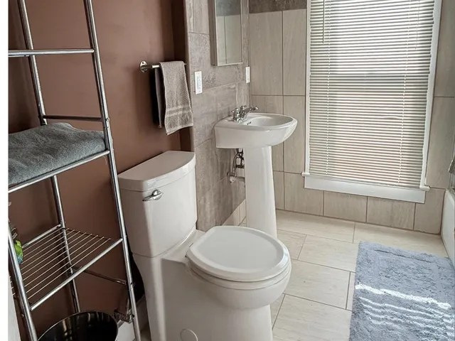 a white toilet sitting next to a bathroom sink