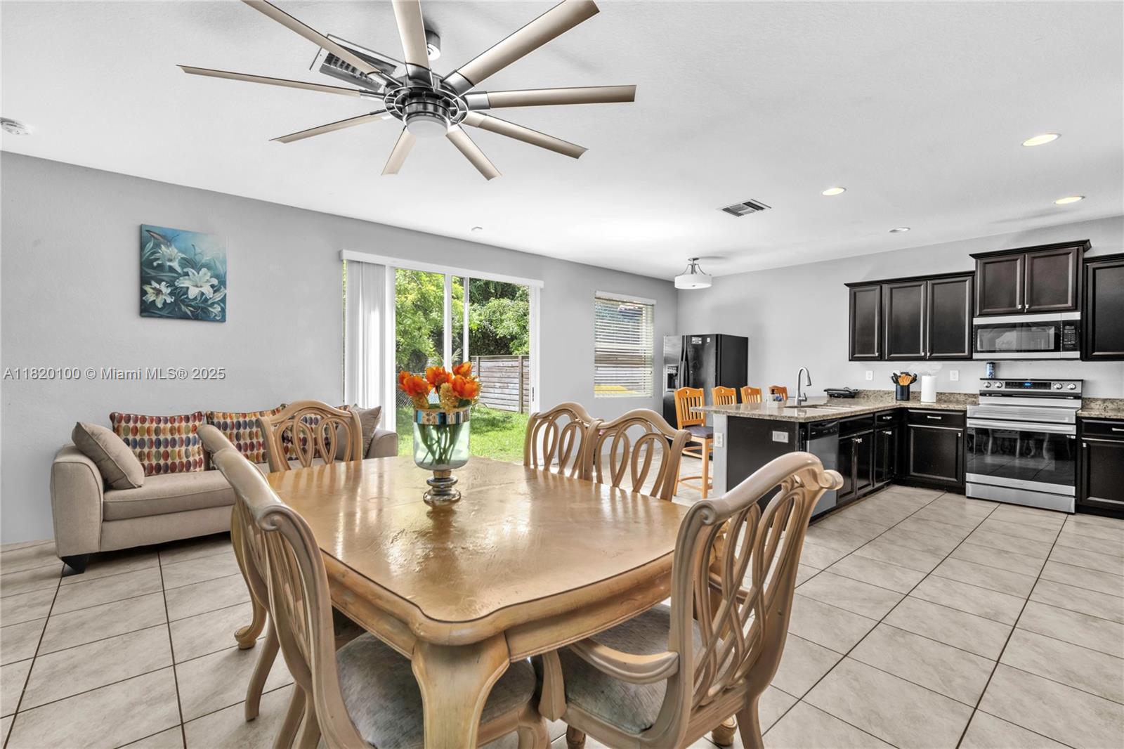 2190 Southeast 2nd Street Homestead, FL 33033 - Photo 12 of 37 a dining room with furniture a kitchen view and a chandelier