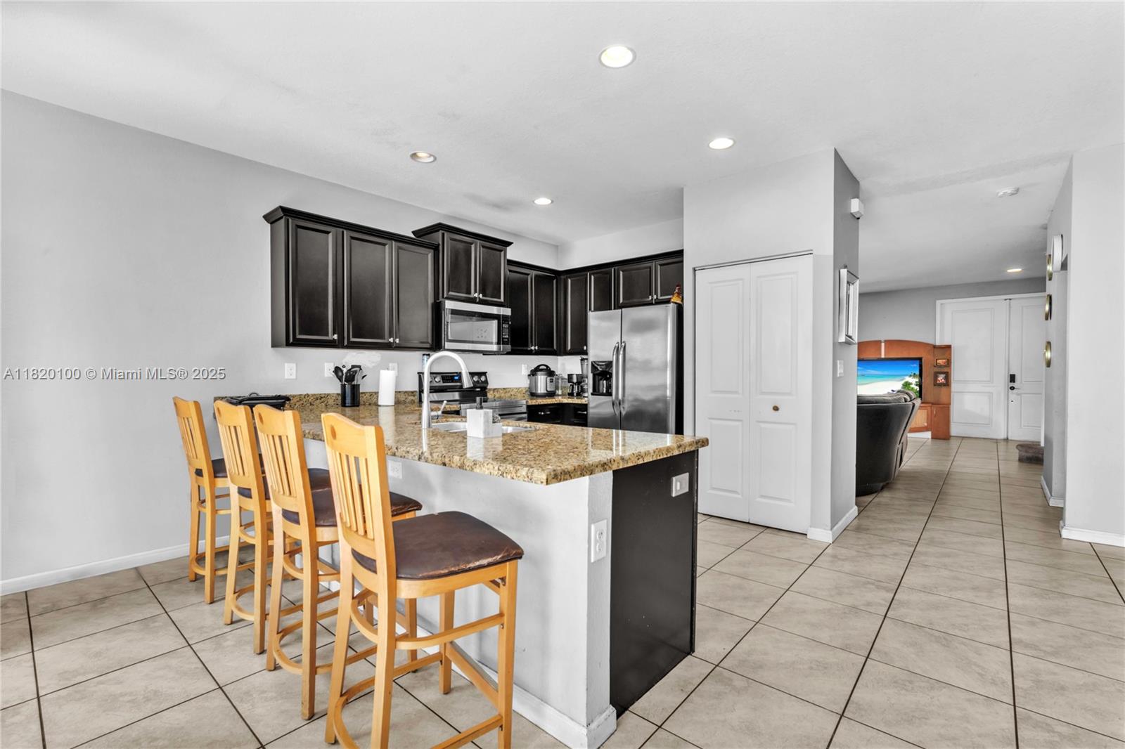 2190 Southeast 2nd Street Homestead, FL 33033 - Photo 13 of 37 a kitchen with stainless steel appliances granite countertop a refrigerator and a stove top oven
