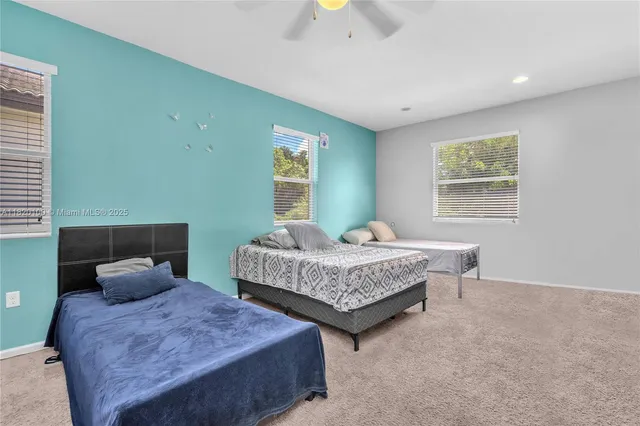 a bedroom with two beds and painted walls