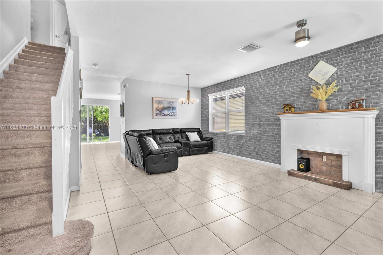 2190 Southeast 2nd Street Homestead, FL 33033 - Photo 5 of 37 a spacious bedroom with a bed a fireplace and window