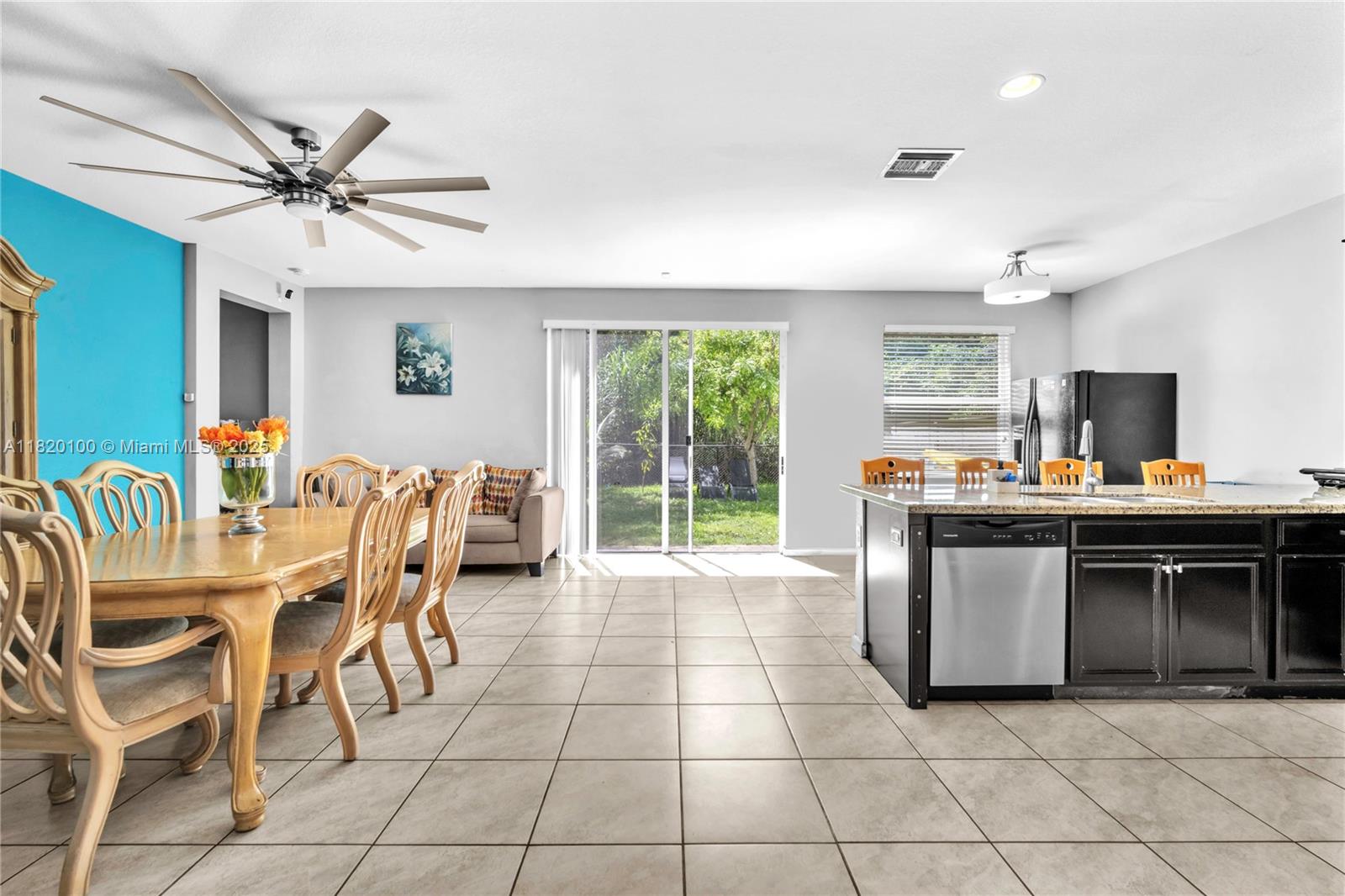 2190 Southeast 2nd Street Homestead, FL 33033 - Photo 10 of 37 a kitchen with a chandelier dining table and stainless steel appliances