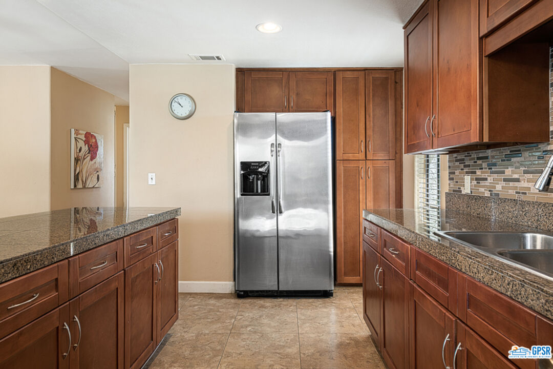 2783 North Cerritos Road Palm Springs, CA 92262 - Photo 17 of 25 a kitchen with stainless steel appliances granite countertop a refrigerator and a sink