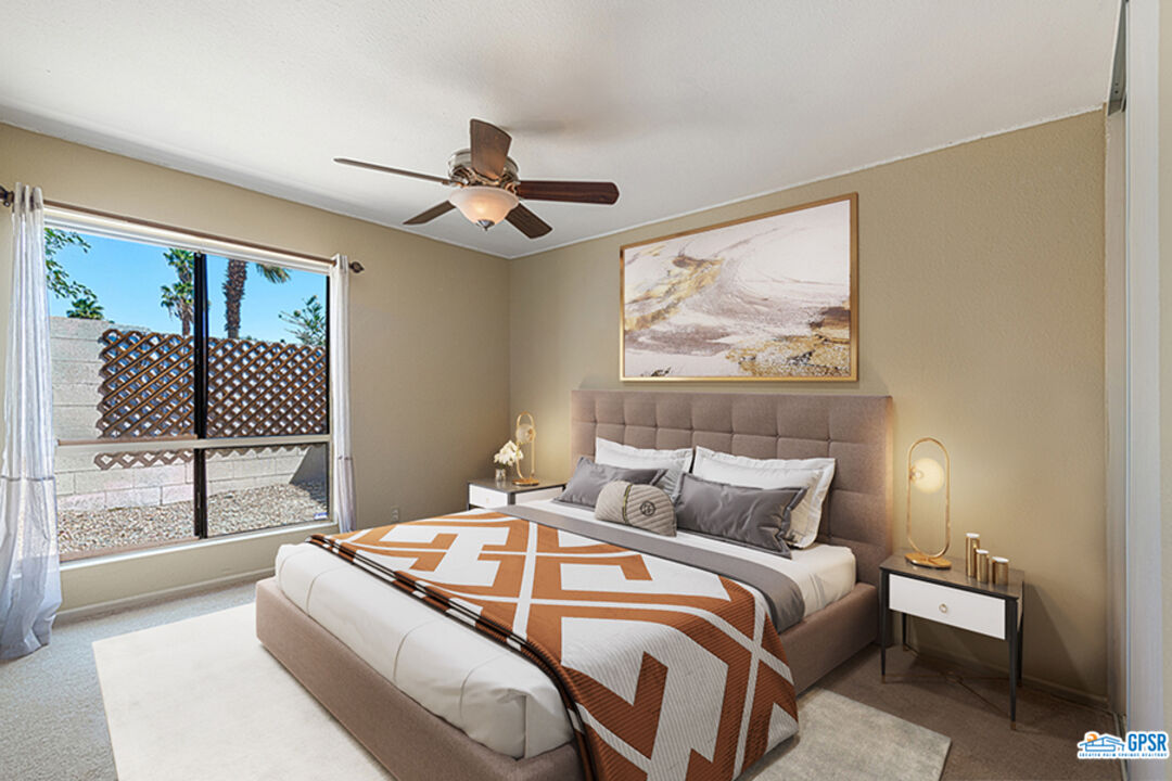 2783 North Cerritos Road Palm Springs, CA 92262 - Photo 21 of 25 a bedroom with a large bed and a chandelier