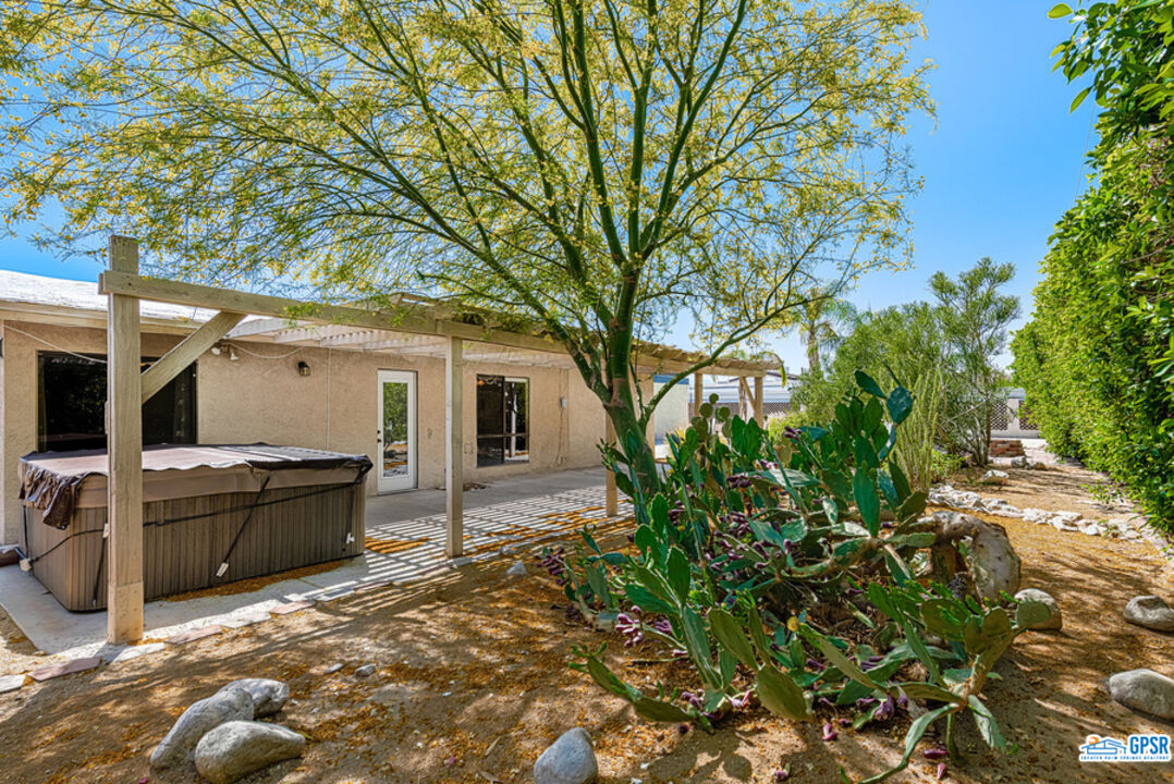 2783 North Cerritos Road Palm Springs, CA 92262 - Photo 7 of 25 a view of a patio with table and chairs with wooden fence and floor