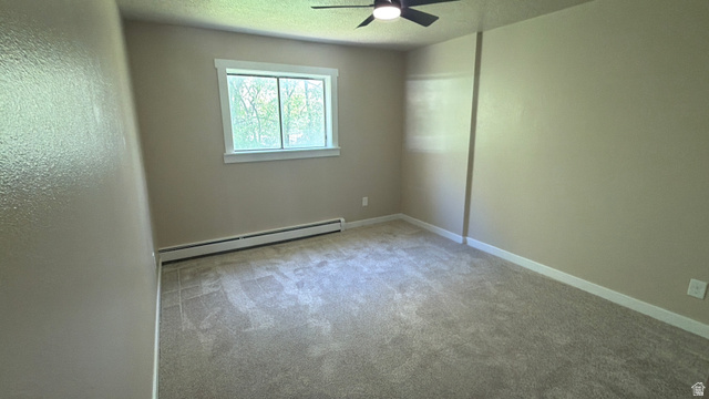 647 Swenson Avenue, Unit 4 Springville, UT 84663 - Photo 11 of 14 Bed 2. Spare room with a baseboard heating unit, light carpet, a textured ceiling, and a ceiling fan