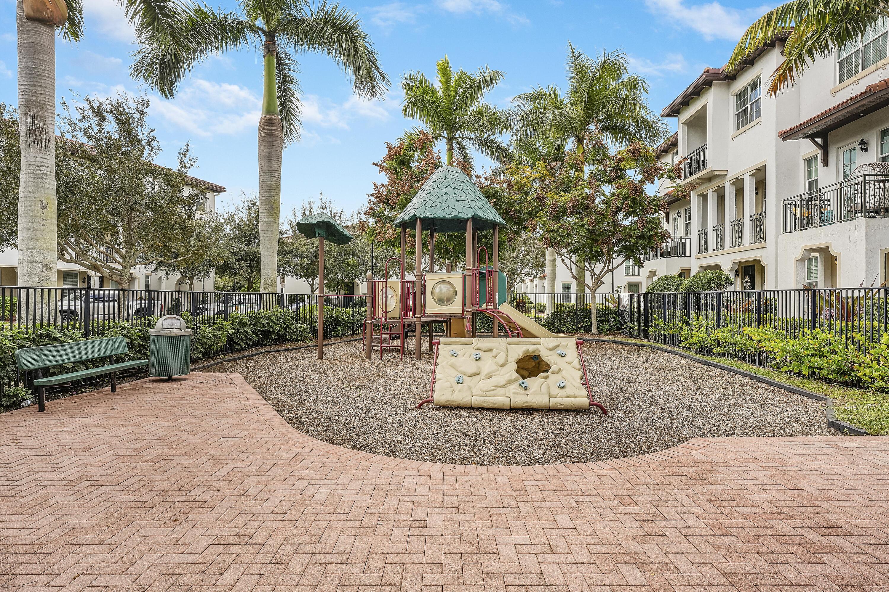 2900 Southwest 119th Way Miramar, FL 33025 - Photo 15 of 37 a palm tree sitting in front of a brick building